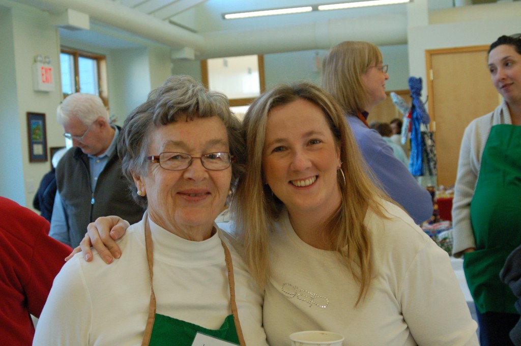 Smiling intergenerational volunteers at the St. Paul's Advent Fair.