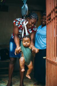 Smiling Haitian mother with child.