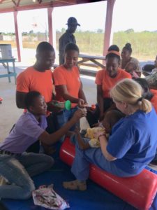 Haitian nursing students checking pulse.